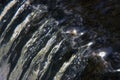 Closeup shot of the crystal water pouring from up to down direction