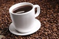 Closeup shot of the cup of black coffee on the roasted coffee beans Royalty Free Stock Photo