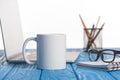 closeup shot of cup, eyeglasses on textbook, laptop and organizer with pens and pencils Royalty Free Stock Photo