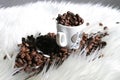 Closeup shot of a cup full of coffee beans on a white soft surface Royalty Free Stock Photo