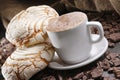 Closeup shot of a cup of latte coffee with sweet pastries Royalty Free Stock Photo
