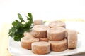 Closeup shot of cut-up circular frozen fish sauce with parsley Royalty Free Stock Photo