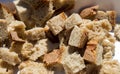 Closeup shot of cut-up and cubed bread on a white plate during daylight Royalty Free Stock Photo