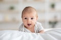 Closeup Shot Of Cute Infant Baby Lying In Bed On His Tummy Royalty Free Stock Photo