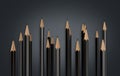 Closeup shot of 3D rendered sharp black graphite pencils on dark grey background