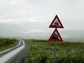 Closeup shot of dangerous roadside and steep descent road signs