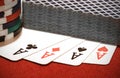 Closeup shot of a deck of playing cards on four aces with a pile of casino chips Royalty Free Stock Photo