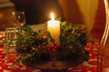 Closeup shot of a decorated burning holiday candle on the table Royalty Free Stock Photo