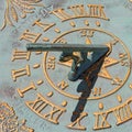 Closeup shot of a decorated old sun clock, compass, and calendar with golden numbers Royalty Free Stock Photo