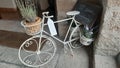 Closeup shot of decorative bicycle with plants and sign