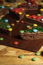 Closeup shot of decorative Christmas tree biscuits on a wooden board