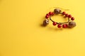 Closeup shot of a decorative wooden trinket isolated on a yellow background