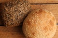 Closeup shot of delicious freshly-made artisanal brown bread with nuts on a wooden surface