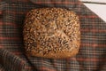 Closeup shot of delicious freshly-made artisanal brown bread with nuts on a wooden surface