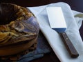 Closeup shot of a delicious homemade marble pound cake on a slate board with a baking spatula Royalty Free Stock Photo