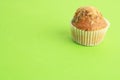 Closeup shot of a delicious homemade muffin on a green surface