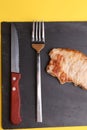 Closeup shot of a delicious homemade steak with a fork and a knife by its side