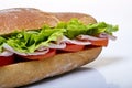 Closeup shot of a delicious sandwich with lettuce, bologna and tomatoes on a white background Royalty Free Stock Photo