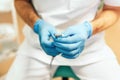 Closeup shot of dentists hands holding dental tool Royalty Free Stock Photo