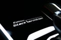 Closeup shot of details on a BMW X6 Black Vermillion Edition center console badge