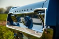 Closeup shot of details on the exterior of a vintage blue Ford Mustang sports car