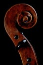 Closeup shot of the details on the head of an old wooden violin isolated on a black background Royalty Free Stock Photo