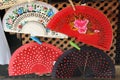 Closeup shot of different traditional Spanish fans hanging in the store Royalty Free Stock Photo