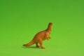 Closeup shot of a dinosaur figurine isolated on a green background