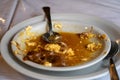 Closeup shot of a dirty plate with the remains of a soup Royalty Free Stock Photo
