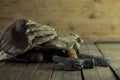 Closeup shot of dirty white gloves on a hammer and a stack of nails on the wooden ground Royalty Free Stock Photo