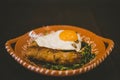 Closeup shot of a dish with egg, sausage and vegetable leaves Royalty Free Stock Photo