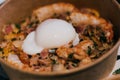 Closeup shot of a dish with undercooked egg with prawns and bacon Royalty Free Stock Photo