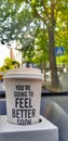 Closeup shot of disposable paper coffee cup with an inspirational quote to strengthen mental health Royalty Free Stock Photo