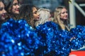 Closeup shot of diverse girls college cheerleaders with shiny blue pompons
