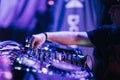 Closeup shot of a Dj playing music on his mixer in a night perform