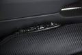 Closeup shot of a door handle with power windows control buttons of a luxury passenger car Royalty Free Stock Photo