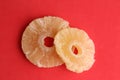 Closeup shot of the dried pineapple slices isolated on a red background Royalty Free Stock Photo
