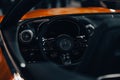 Closeup shot of the driving wheel of the Mercedes-Benz AMG SL with blur background