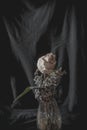 Closeup shot of dry white rose in a glass vase isolated in black background Royalty Free Stock Photo