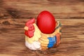 Closeup shot of an Easter egg in a chicken-themed ornament Royalty Free Stock Photo