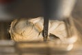 closeup shot of an electric dough mixer machine kneading the dough