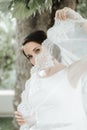 Closeup shot of elegant, brunette bride posing under veil closeup Royalty Free Stock Photo