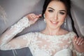 Closeup shot of an elegant, brunette bride in vintage white dress posing under veil closeup Royalty Free Stock Photo