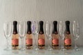 Closeup shot of elegant rose pink champagne bottles and glasses