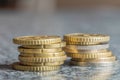 Closeup shot of euro coins stacked on each other in different positions on a blurred background Royalty Free Stock Photo