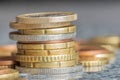 Closeup shot of euro coins stacked on each other in different positions on a blurred background Royalty Free Stock Photo