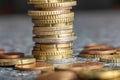 Closeup shot of euro coins stacked on each other in different positions on a blurred background Royalty Free Stock Photo