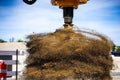 Closeup shot of an excavator with drill attachment spinning off dirt Royalty Free Stock Photo