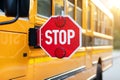 Closeup shot of extended red stop sign on yellow school bus Royalty Free Stock Photo