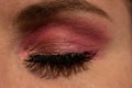 Closeup shot of eye makeup with pink shadow and heavy mascara